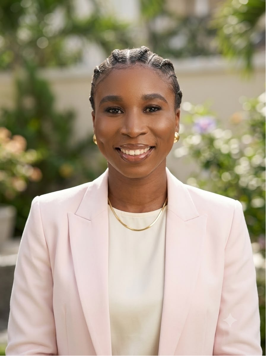 Olayinka Adejoro in a pale pink blazer outdoors